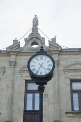 A round clock with Roman numerals . Azerbaijan, Baku . 01.01.2000 . clock on top of a famous tower .