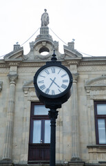 A round clock with Roman numerals . Azerbaijan, Baku . 01.01.2000 . clock on top of a famous tower .