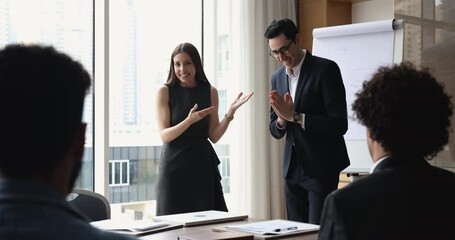 Happy excited company boss introducing successful coach to team of employees, giving handshake to best manager to colleague, expressing recognition, appraisal, thanking for good job, getting applause