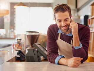 Businessman, barista and cafe with phone call for online service, conversation order at coffee shop. Happy man, waiter or business owner with smile on mobile smartphone in discussion at restaurant