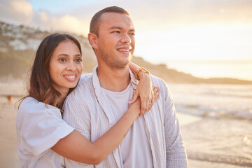 Obraz premium Happy, couple and hug on beach with love, bonding and romance date for tropical travel in Greece. Smile, woman and man with embrace of relationship, commitment and loyalty for ocean sunset outdoor