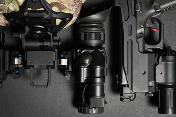 Naklejka premium Tactical gear, head-mounted night vision goggles and a pistol with flashlight.