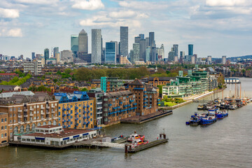 Thames river embankment with Canary Wharf skyscrapers at background, London, UK