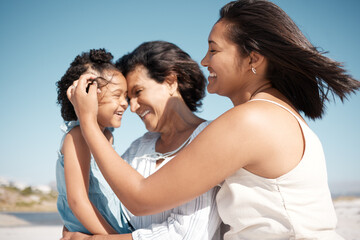 Obraz premium Outdoor, grandma and mom with child, beach and old woman with granddaughter, bonding and break. Happy, girl and generations on vacation, sea and relax in holiday, travel or love of family in Portugal