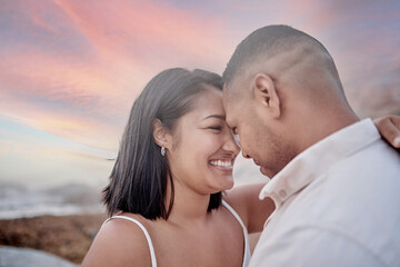 Fototapeta premium Smile, connection and couple on beach at sunset on romantic date for travel with vacation or weekend trip. Love, commitment and young man and woman bonding by ocean in evening on tropical holiday.