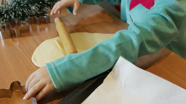 Cute child little elf making christmas ginger bread cookies. High quality 4k footage
