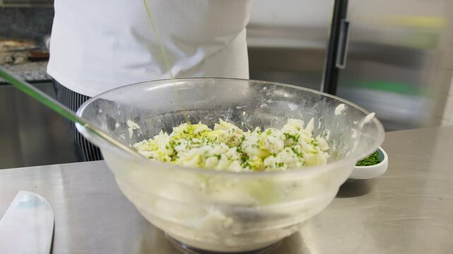 Pour Extra Virgin Olive Oil Into A Raw Fish Based Mixture In A Restaurant