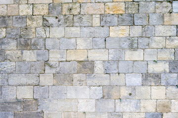 Beige and grey stone wall, can be used as a background