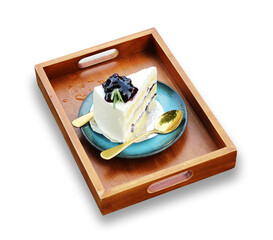 Wooden box tray with piece of cake and spoon cafe. This has clipping path.