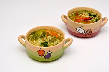 two bowls with soup on a white background