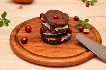chocolate pancakes with cranberries on a board