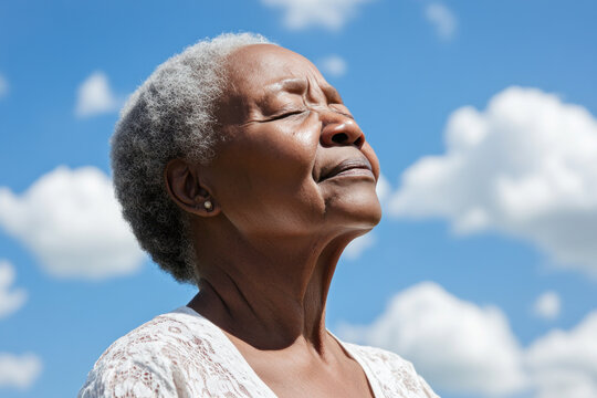 African senior woman taking a breath on a sunny day, mental health