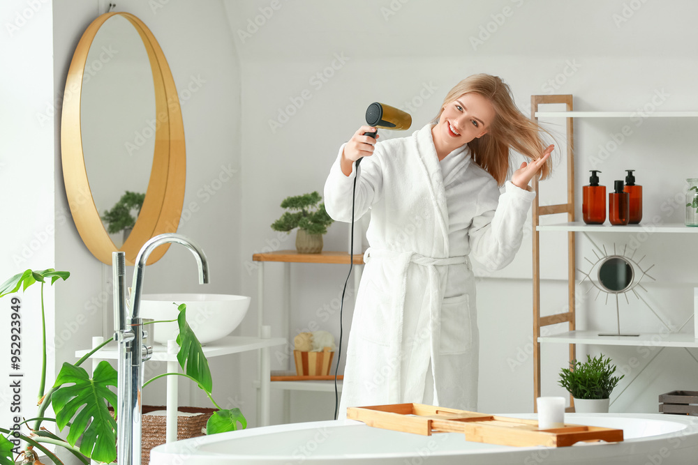 Sticker pretty young woman drying hair in bathroom