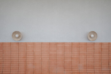A minimalist design featuring a textured white wall and a terracotta tiled section, accented by two...