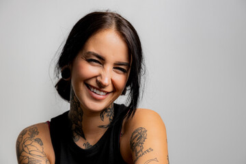 Tattooed girl with a modest smile
