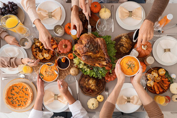 Happy family having dinner at festive table on Thanksgiving Day, top view
