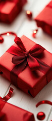 Close-up of a beautifully wrapped red gift box with a ribbon on a white background. Perfect for holiday, Christmas, or special occasion themes.