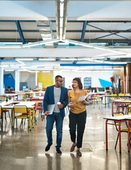 Creative, people and walking with conversation in office for project updates, design technique and...