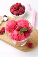 Delicious raspberry sorbet, mint and fresh berries on white wooden table, closeup