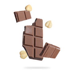 Pieces of tasty chocolate and hazelnuts falling on white background