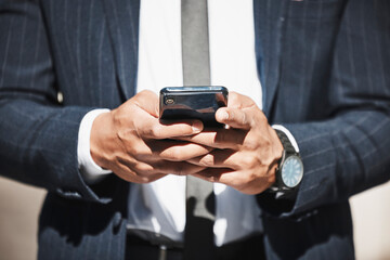 Businessman, hands and online with smartphone in city for conversation with client, texting and networking apps. Person, corporate employee and internet for professional communication outdoor