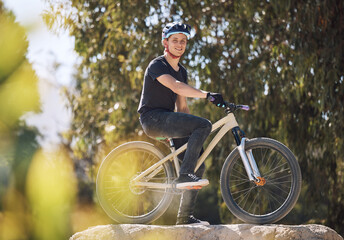 Fototapeta premium Sports, happy and portrait of man on bicycle for training, workout and exercise in countryside. Fitness, cycling and person with mountain bike for adventure, freedom and adrenaline on dirt trail