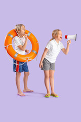 Little children lifeguards with ring buoy, megaphone and whistle on purple background