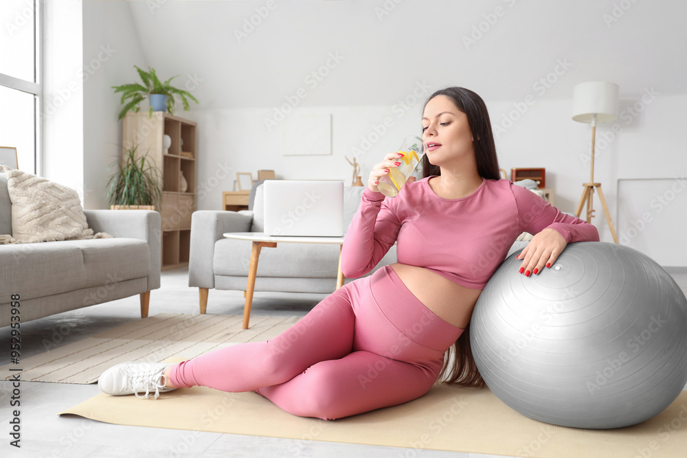 Canvas Prints sporty pregnant woman with fitball drinking lemon water at home