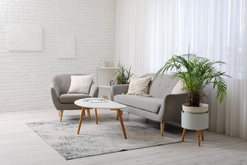 Interior of modern light living room with comfortable sofa