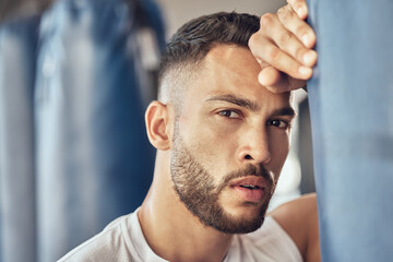 Obraz premium Exhausted man, portrait and boxer with punching bag for self defense training, practice or martial arts at gym. Tired male person or fighter in fitness for break after intense exercise or boxing