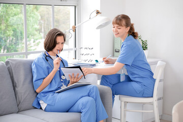 Female medical interns studying in clinic