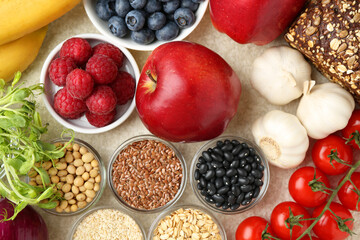 Different fresh products on grey table, flat lay. Source of prebiotics