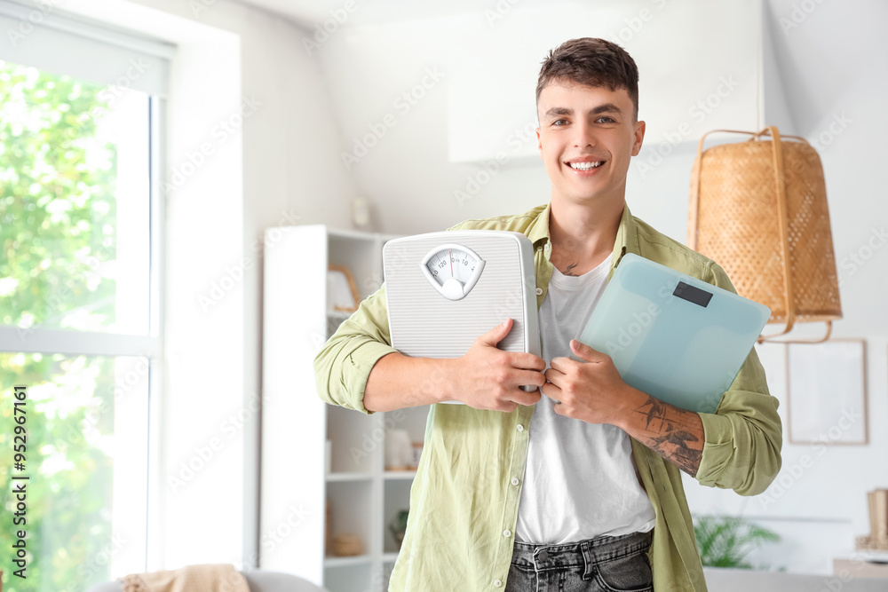 Canvas Prints Young man with weight scales at home