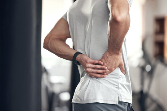 Hip pain, man and fitness injury at gym for boxing, sport and training with accident at health center. Wellness, hands and exercise of an athlete with hurt joint and scoliosis concern of spine