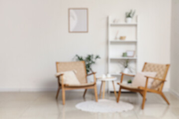 Interior of modern stylish living room with armchairs and shelving unit, blurred view