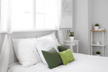 Stylish comfortable bed with pillows at home, closeup