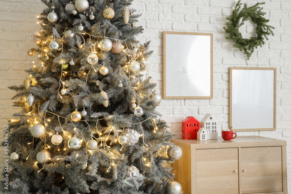 Wall mural christmas tree with festive decorations and wooden cabinet near white brick wall