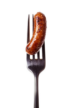 a sausage on a fork, isolated on a transparent background - a close up view of a perfect bite of a classic appetizer item, mini hot dog, little smoky hot dog