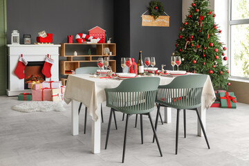 Interior of room with dining table, fireplace and Christmas tree