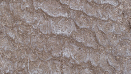 Abstract image of intricate patterns formed in the sand of a beach