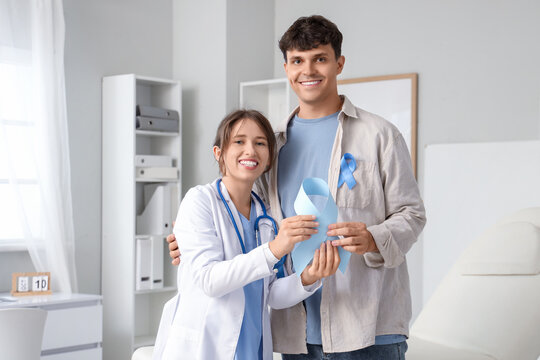Young man and female doctor with blue ribbon in clinic. Prostate cancer awareness concept