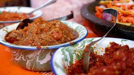 Various types of Indonesia chili sauce or Sambal on an enamel bowl.