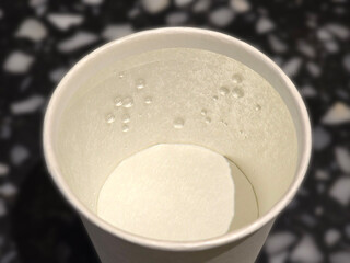 A paper cup of water focus on bubbles inside 