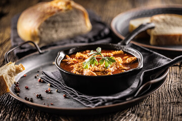 Tasty soup or stew made of beef tripe and spices. Spicy and aromatic tripe soup seasoned with pepper and served with bread