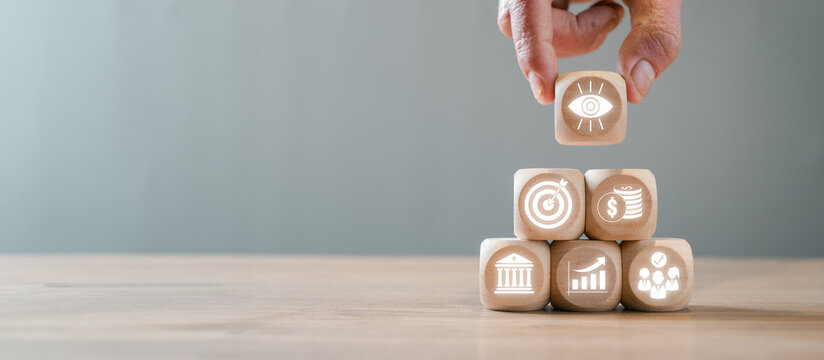Wooden blocks illustrating the balanced scorecard concept, showcasing business strategy, performance metrics, and key performance indicators.