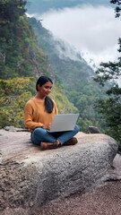 Fototapeta premium ecology young woman laptop rock sitting forest