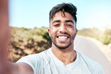 Portrait, selfie and man with smile, fitness and proud of muscle, outdoor or runner in nature for exercise. Confident, sporty and wellness of athlete with workout, bokeh or training of healthy person