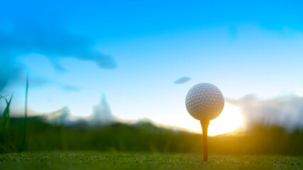Golf ball on green grass in the evening golf course with sunshine background.