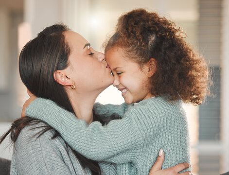 Mother, daughter and forehead kiss with affection, love and care in family home, bonding and together. Female person, child and embrace in living room for happiness, connection and positive as parent