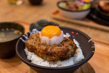 Hamburg steak on rice bowl, with fresh egg on the top. Japanese food